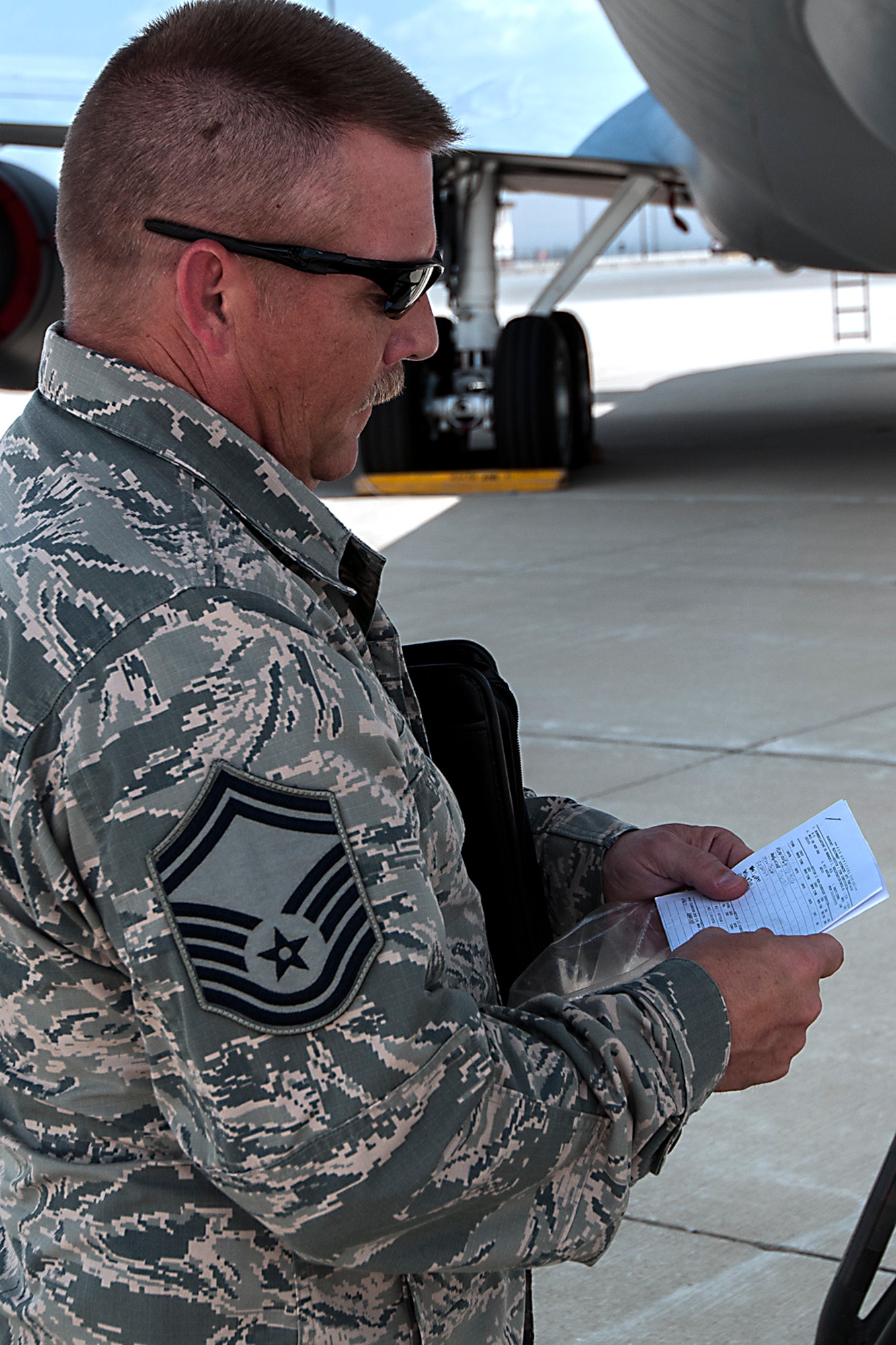 Senior Master Sgt. Michael Young, 434th Maintenance Group quality assurance inspector, examines the form for a stand in use on the flightline July 13, 2016 at Grissom Air Reserve Base, Ind. Young is making sure that the form was filled out correctly before the stand was used and that all safety precautions are being followed. (U.S. Air Force photo/Senior Airman Dakota Bergl) 