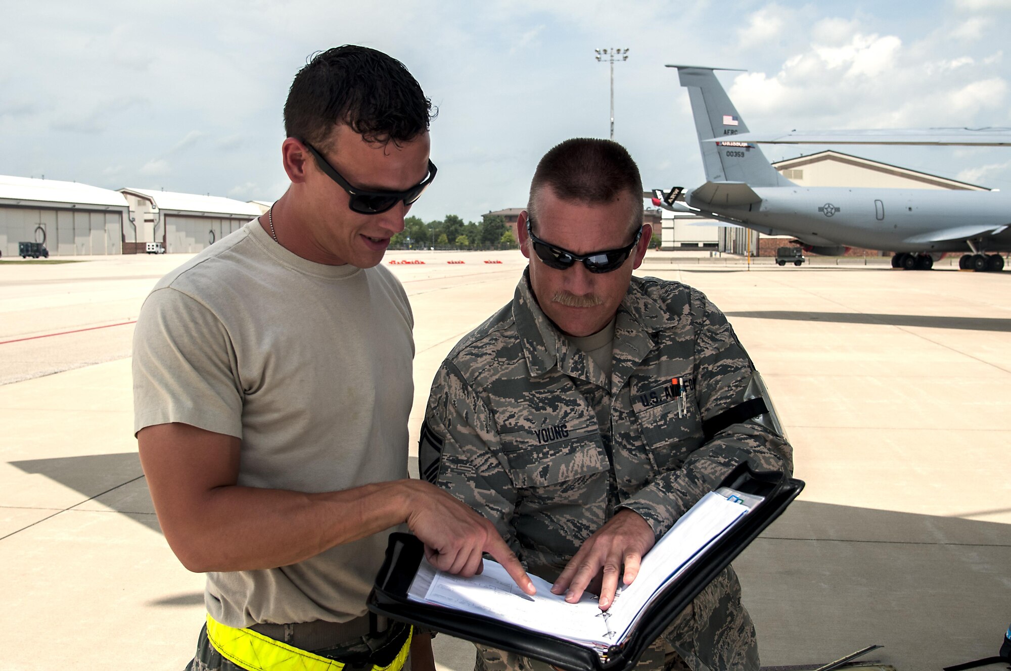 Tech. Sgt. Ryan Strole, 434th Aircraft Maintenance Squadron crew chief, and Senior Master Sgt. Michael Young, 434th Maintenance Group quality assurance inspector, review aircraft forms during an evaluation July 13, 2016 at Grissom Air Reserve Base, Ind. The evaluation ensures that all safety guidelines are being followed and all work is being noted in the aircraft forms for future reference. (U.S. Air Force photo/Senior Airman Dakota Bergl)