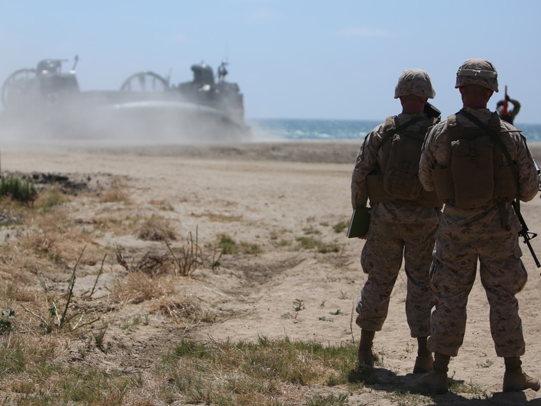 U.S. Marines with Landing Support Company, 1st Transportation Support Battalion, 1st Marine Logistics Group, observe the beaching of a landing craft, air cushion during PACOM Amphibious Leaders Symposium – 16 aboard Camp Pendleton, Calif., July 13, 2016. Several 1st MLG units and Beachmaster Unit 1, Naval Beach Group 1 facilitated the offload of equipment and personnel during the symposium’s beach landing operations demonstration. (U.S. Marine Corps photo by Sgt. Carson Gramley/released)