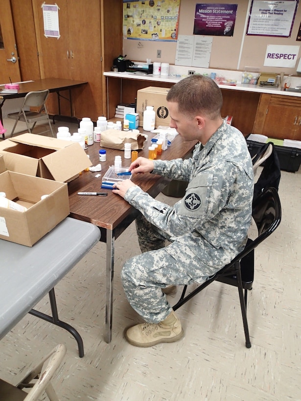 Pfc. Michael Fiedor, a pharmacy technician from Company A, 48th Combat Support Hospital, Fort Story, Va., counts out medication for a patient during Greater Chenango Cares, July 19, 2016.  Greater Chenango Cares is one of the Innovative Readiness Training events which provides real-world training in a joint civil-military environment while delivering world class medical care to the people of Chenango County, N.Y., from July 15-24.