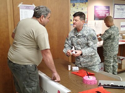 Maj. Timothy Dwyer, a pharmacist from the 1192nd Distribution & Distribution Support Brigade (DDSB), New Orleans, La., instructs a patient on proper medication usage during the Greater Chenango Cares Innovative Readiness Training event, July 19, 2016.  Greater Chenango Cares is one of the Innovative Readiness Training events which provides real-world training in a joint civil-military environment while delivering world class medical care to the people of Chenango County, N.Y., from July 15-24.