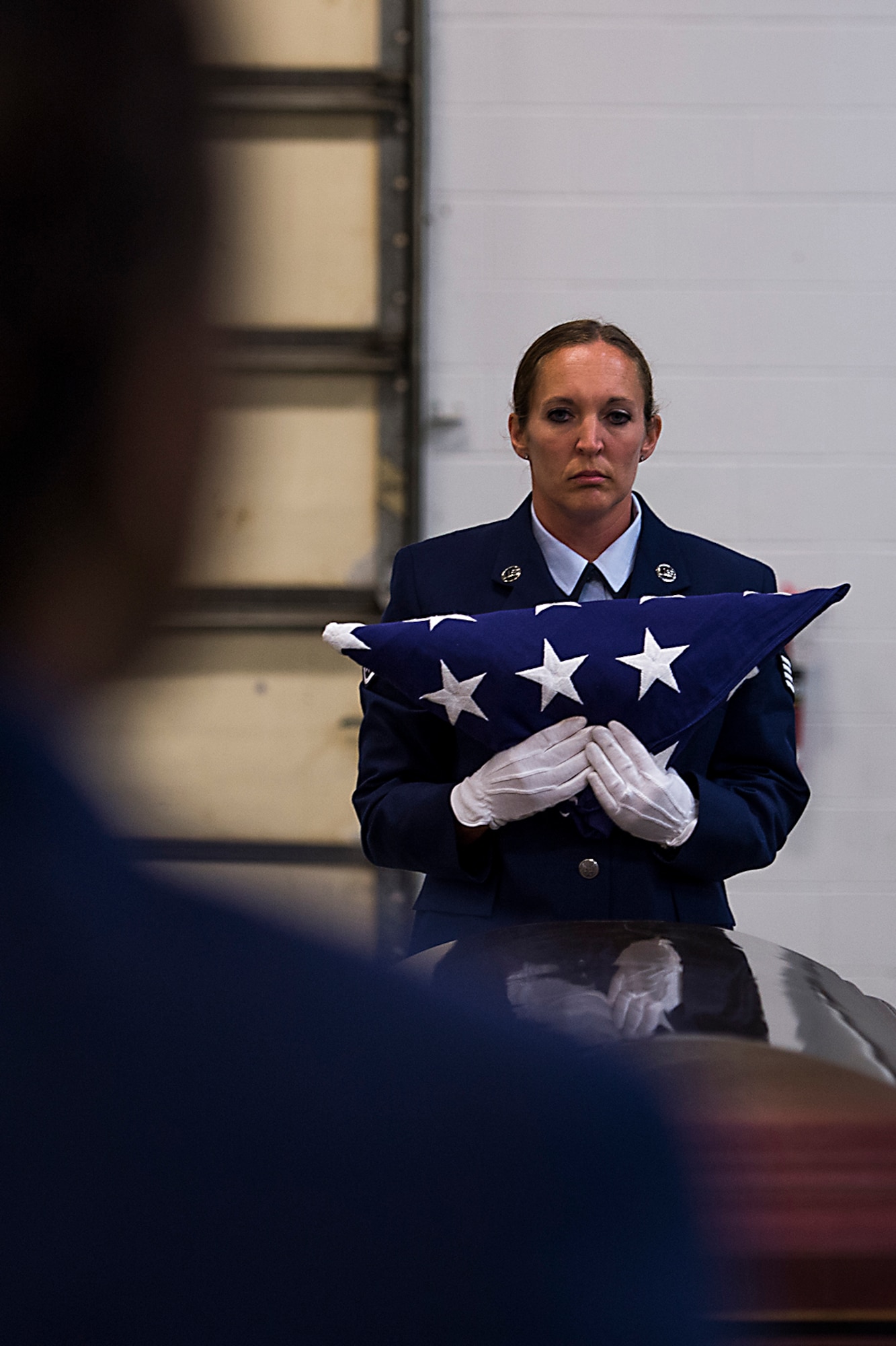 Staff Sgt. Brandie Bucinski, 434th Aircraft Maintenance Squadron, holds a flag following a demonstration of proper flag folding technique during an Honor Guard graduation ceremony July 15, 2016 at Grissom Air Reserve Base, Ind. Grissom’s Honor Guard primarily preforms funeral duties for military retirees and veterans. (U.S. Air Force photo/Senior Airman Dakota Bergl)
