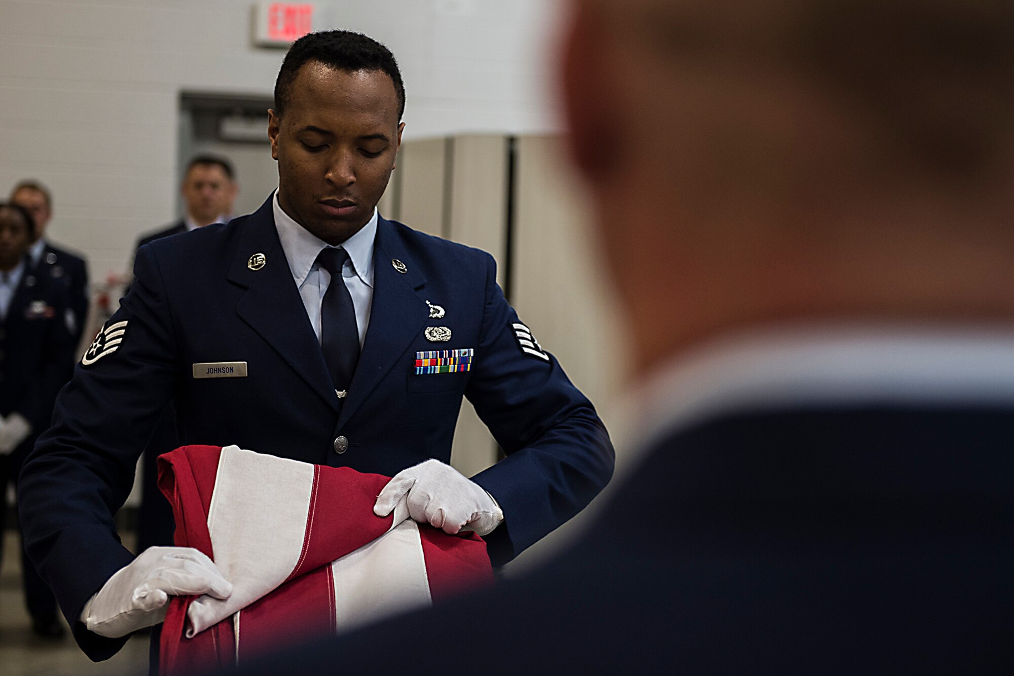 Staff Sgt. Bernard Johnson, 434th Financial Management, slowly and precisely folds the American flag during an Honor Guard graduation ceremony July 15, 2016 at Grissom Air Reserve Base, Ind. The flag folding was part of a demonstration showcasing what the graduates learned during the Honor Guard training course. (U.S. Air Force photo/Senior Airman Dakota Bergl)