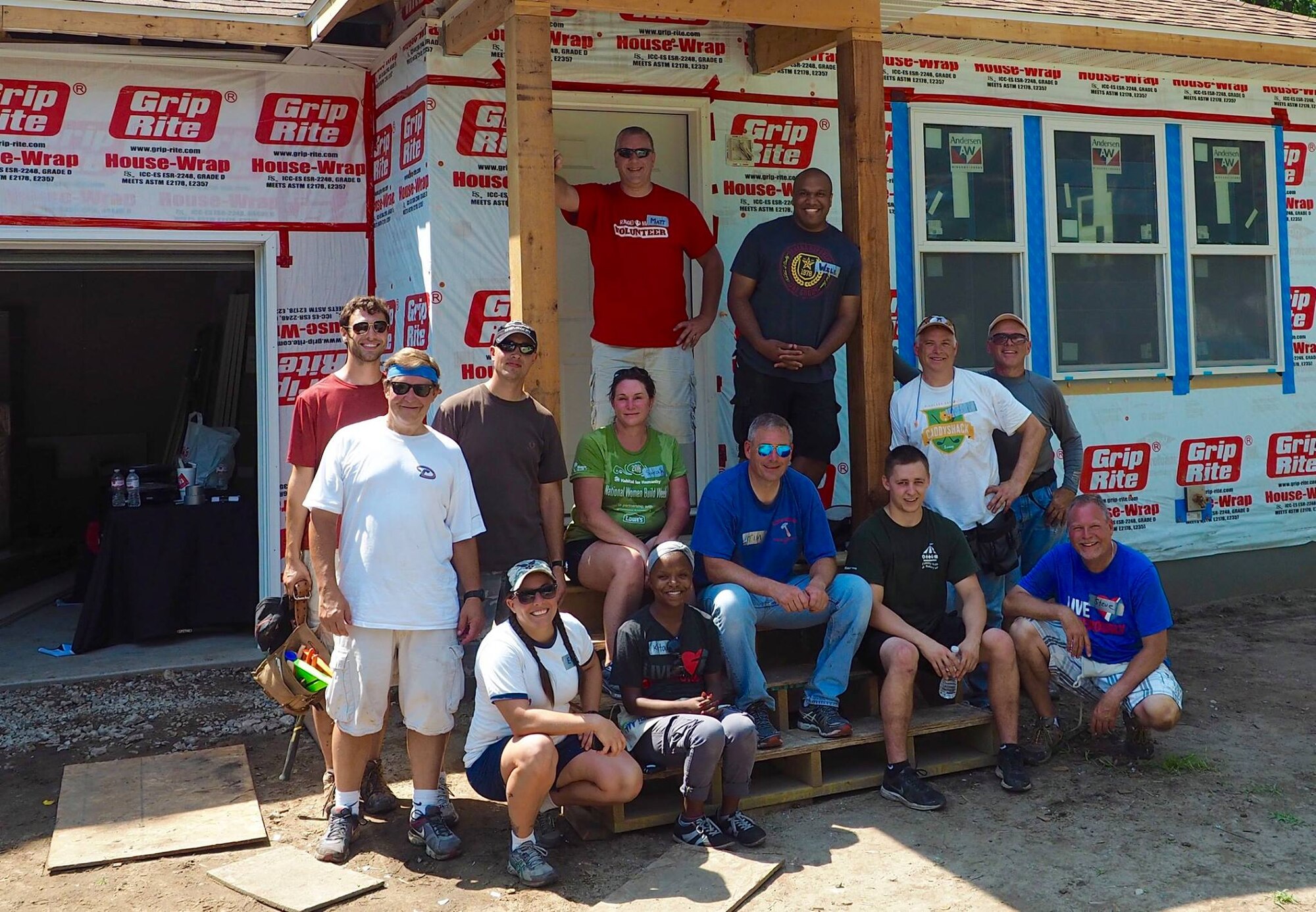 934th Airlift Wing and Habitat for Humanity volunteers pose in front of a home they helped to build in Bloomington, Minn.