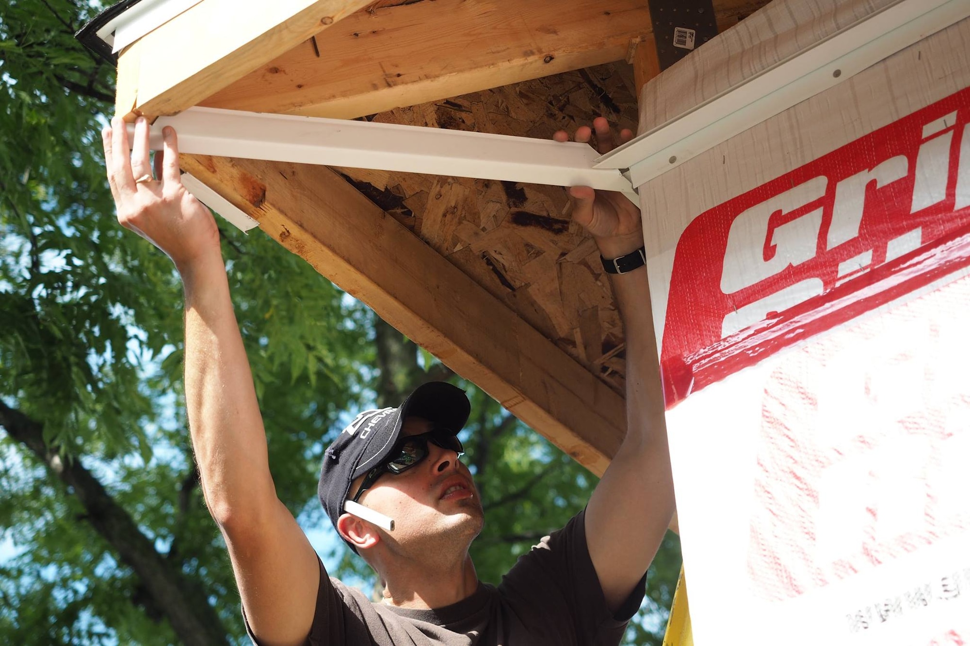 Capt. Adam Ebacher, 96th Airlift Squadron C-130 navigator, takes measurements for soffit bracing during the Habitat for Humanity home construction project July 20.
