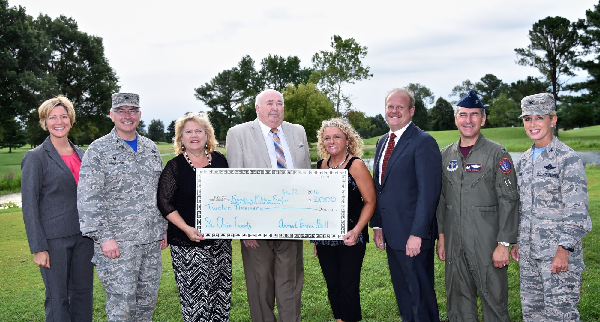 Civic leaders from the St. Clair County Armed Forces Ball Committee presented a check to Scott Air Force Base commanders and representatives for Friends of Military Families, Friends of the 932nd Airlift Wing, and 126th Refueling Wing July 22, 2016, Scott Air Force Base, Illinois.  The donation will be divided among the private organizations that provide support to active duty, reserve and air national guard Airmen and their families. The committee raised the funds as part of their 2nd Annual Armed Forces Ball, which was organized to honor military service members, past and present. The inaugural event took place May 8, 2015, in Fairview Heights, Illinois. (U.S. Air Force photo/Christopher Parr) 