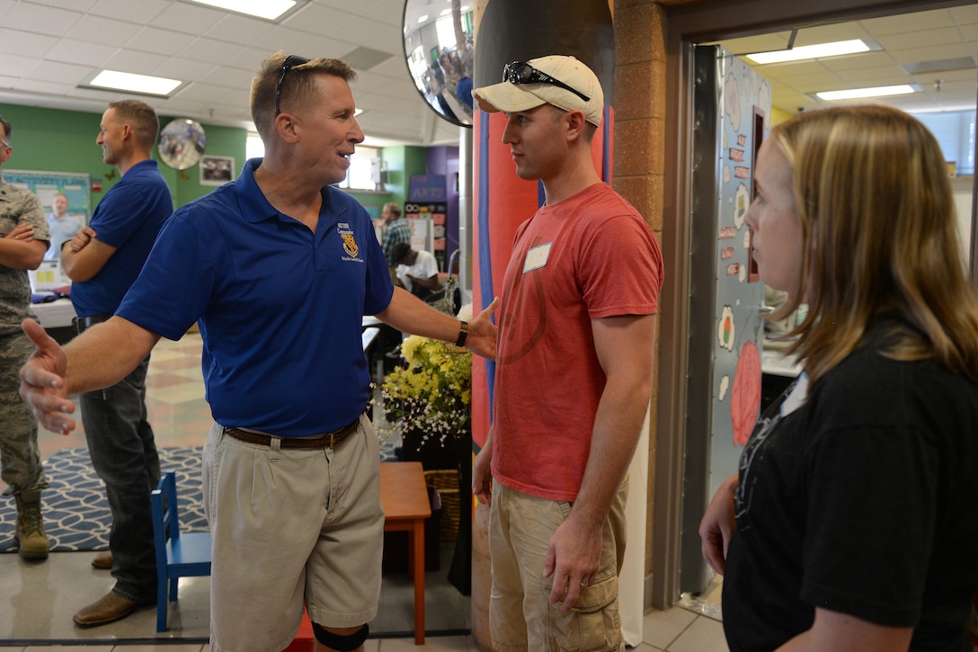 Brig. Gen. Patrick Doherty, 82nd Training Wing commander, welcomes Staff Sgt. Joseph Caughron, 364th Training Squadron hydraulics instructor, and his wife, Casey, to Sheppard Air Force Base, Texas, July 20, 2016. Doherty along with several other base helping agencies were on hand to welcome new families to the base during the summer family picnic. (U.S. Air Force photo by Senior Airman Kyle E. Gese/Released)