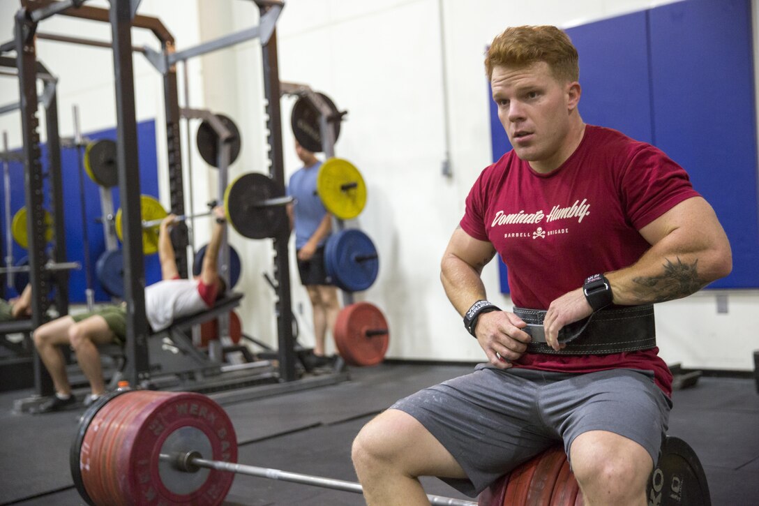 Sgt. Ryan King, section chief, K Battery, 3rd Battalion, 11th Marine Regiment, tightens the strap on his protective belt at the East Gym aboard the Marine Corps Air Ground Combat Center, Twentynine Palms, Calif., July 14, 2016.