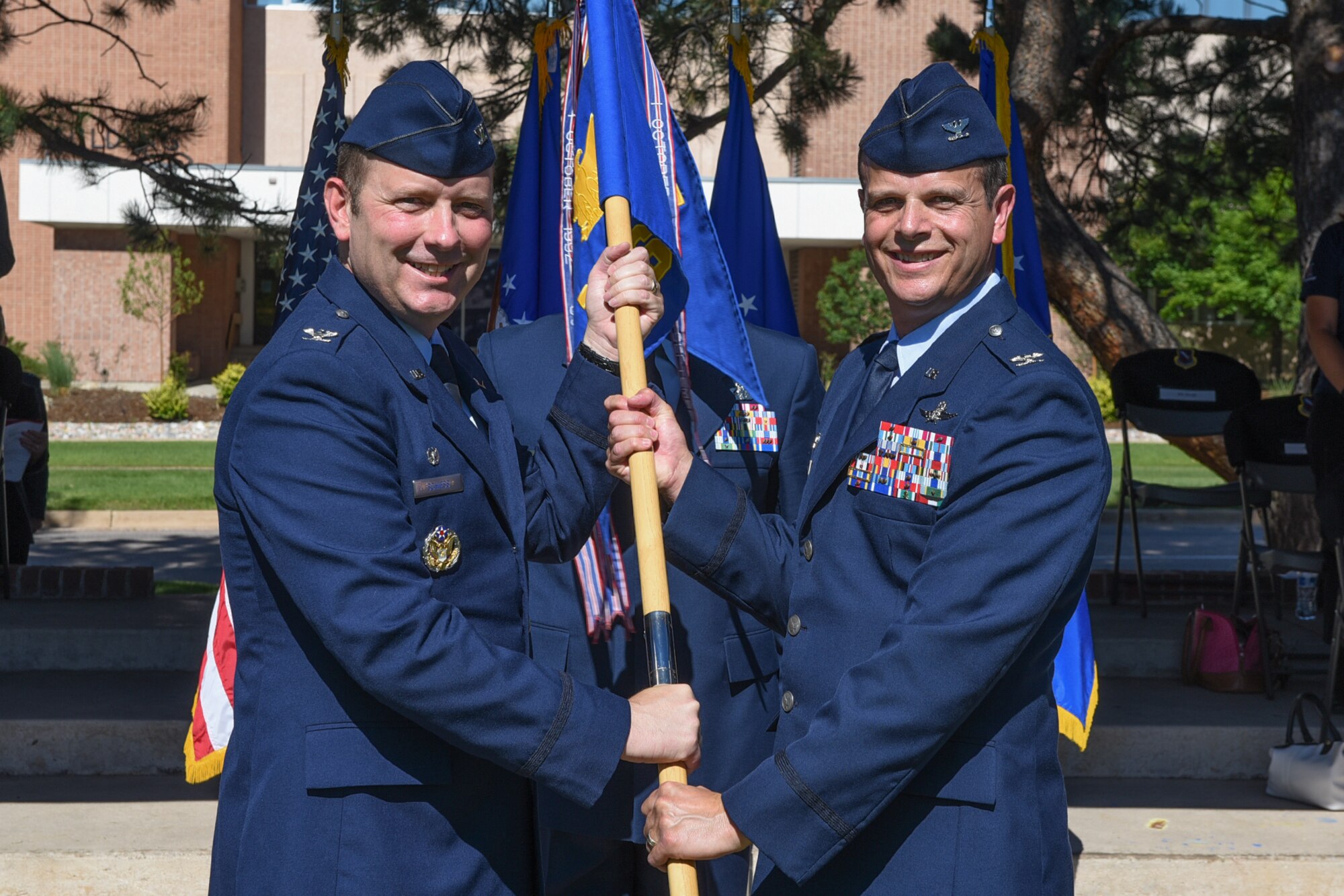 PETERSON AIR FORCE BASE, Colo. – Col. Douglas Schiess, 21st Space Wing commander, passes the guidon to Col. Timothy Ryan as he assumes command of the 21st Mission Support Group on July 21, 2016 at Peterson Air Force Base, Colo. The 21st MSG provides civil engineering, communications,  contracting, logistics, personnel, security, and services support  to squadrons operating worldwide to execute their missile warning and space control missions. (U.S. Air Force photo by Philip Carter)