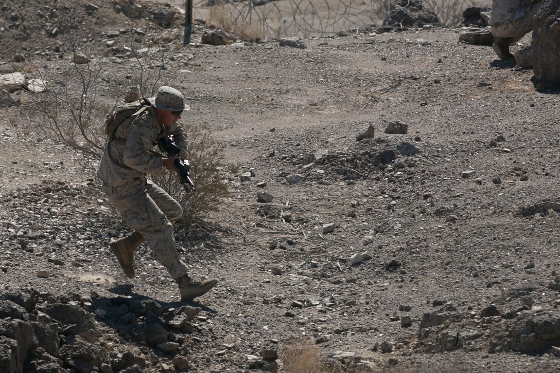 Cpl. Andrew Greenfield, squad leader, 3rd Battalion, 4th Marines, 7th Marine Regiment, runs to cover during immediate action practical application exercise held as part of the Tactical Small Unit Leaders’ Course aboard Marine Corps Air Ground Combat Center, Twentynine Palms, Calif., July 14, 2016. (Official Marine Corps photo by Cpl. Thomas Mudd/Released)