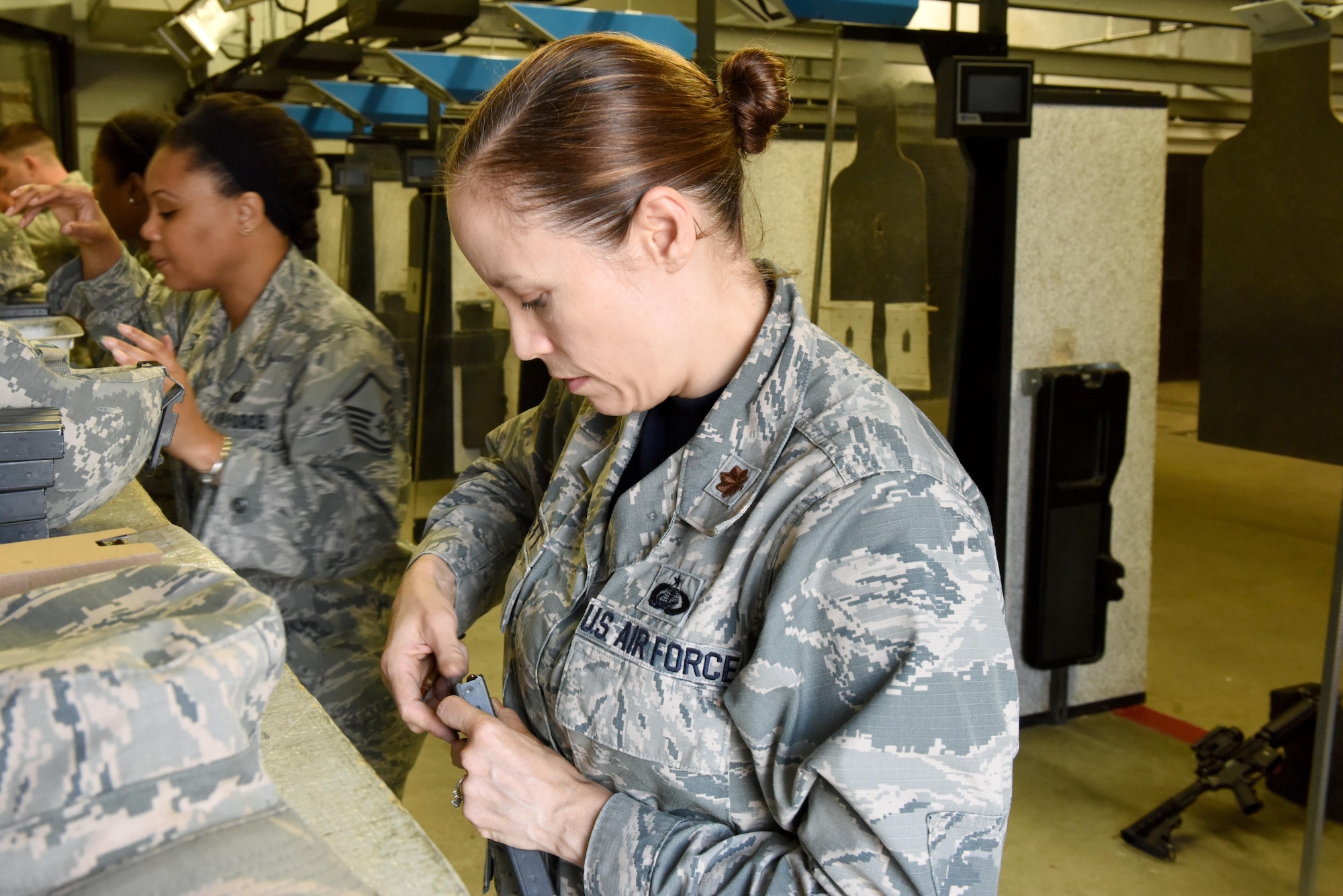 Maj. Coulette Swiggett, 4th Force Support Squadron operations officer, loads a magazine with ammunition during a Combat Arms Training and Maintenance class July 22, 2016, at Seymour Johnson Air Force Base, North Carolina. Airmen must qualify in different portions of shooting before they can be certified and released for deployment. (U.S. Air Force photo by Airman Miranda A. Loera)