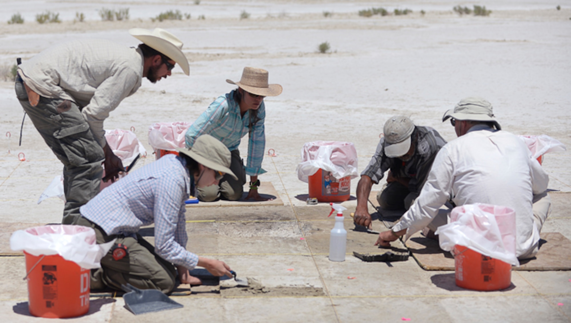 Archaeologists excavate a site on the Utah Test and Training Range, July 13, 2016. The team found tools, charcoal, water fowl bone fragments, and tooling flakes, which provide evidence of wetlands and human presence in the area more than 12,000 years ago. (U.S. Air Force photo by Todd Cromar)