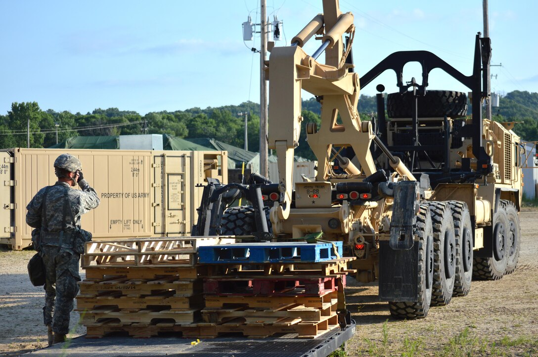 Army Reserve Spc. Collin J. Mulligan, 639th Transportation Company, Bedford, Virginia, directs the M978 A4 Heavy Expanded Mobility Tactical Truck (Hemtt) to pick a load of pallets during Warrior Exercise (WAREX) 86-16-03 at Fort McCoy, Wis., July 20, 2016. WAREX is designed to keep Soldiers all across the United States ready to deploy. (U.S. Army photo by Thomas Watters/Released)