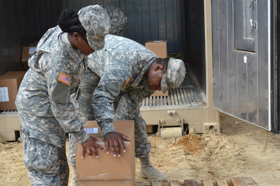 Army Reserve Pvt. Kreshaun J. Rawtingson, 282nd Quartermaster, Montgomery, Alabama, loads supplies with a fellow Soldier on pallets to be picked up during Warrior Exercise (WAREX) 86-16-03 at Fort McCoy, Wis., July 18, 2016. WAREX is designed to keep Soldiers all across the United States ready to deploy.
