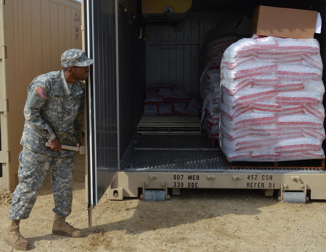 Army Reserve Pfc. Ledarrius Smith, of 282nd Quartermaster, Montgomery, Al., secures ice pallets in cold storage during Warrior Exercise (WAREX) 86-16-03 at Fort McCoy, Wis., July 19, 2016. WAREX is designed to keep Soldiers all across the United States ready to deploy.   (U.S. Army photo by Spc. Joseph Driver/Released)
