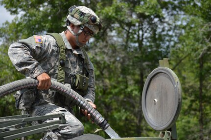 Army Reserve Sgt. Yun Nam, 968th Quartermaster, Tustin, California, fills an M-149 water buffalo during Warrior Exercise (WAREX) 86-16-03 at Fort McCoy, Wis., July 18, 2016. WAREX is designed to keep Soldiers all across the United States ready to deploy.