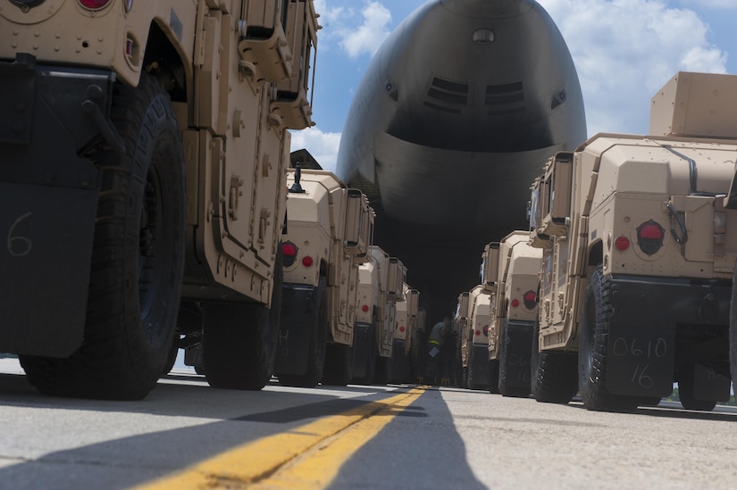 Humvees are prepared by the 305th APS to be loaded onto a C-5 Super Galaxy at Joint Base McGuire-Dix-Lakehurst, N.J., July 21, 2016. The 50 mission essential Humvees are on their way to Iraq in support of Operation Inherent Resolve. 