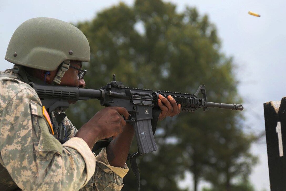 Army Pfc. Michael Parnell fires his M-4 rifle during the Fourth Annual Spc. Hilda I. Clayton Best Combat Camera Competition at Fort A.P. Hill, Va., July 12, 2016. Parnell is assigned to the 55th Signal Company (Combat Camera). Army photo by Pfc. Noel Toye