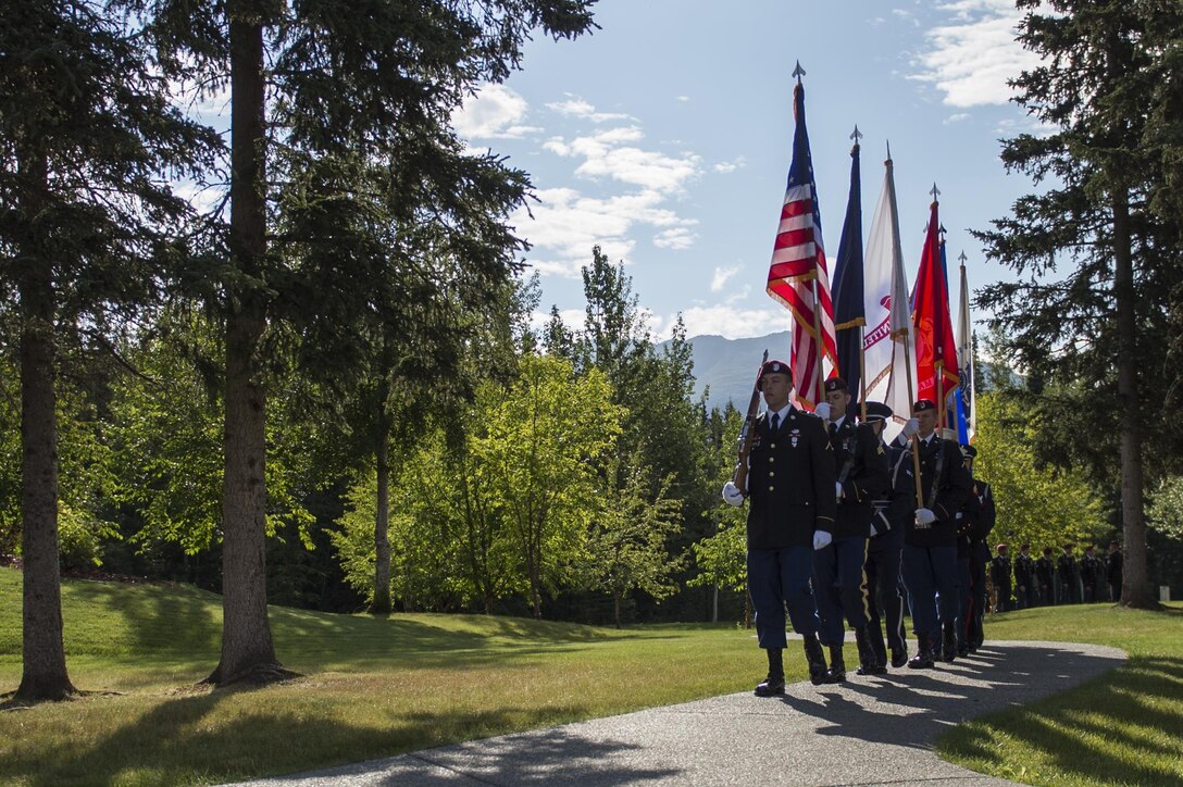 Joint Base Elmendorf-Richardson's Joint Color Guard presents the colors during the Gold Star Wives of America memorial ceremony at the Fort Richardson National Cemetery, July 15, 2016 on Joint Base Elmendorf-Richardson, Alaska.  The memorial ceremony was a part of the Gold Star Wives of America's annual convention hosted this year in Anchorage, Alaska. 