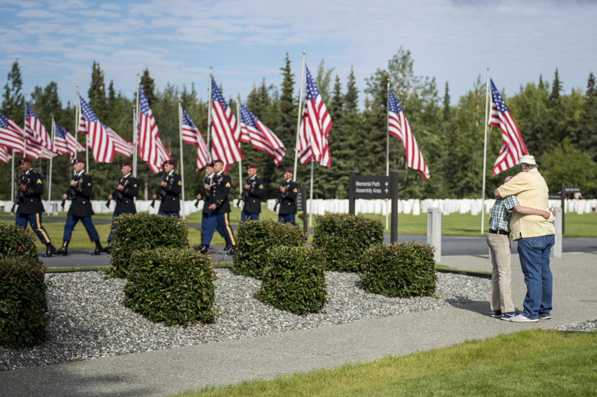 A Gold Star wife hugs her grandson during a memorial ceremony at the Fort Richardson National Cemetery, July 15, 2016 on Joint Base Elmendorf-Richardson, Alaska.  The memorial ceremony was a part of the Gold Star Wives of America's 71st National Convention hosted this year in Anchorage, Alaska. 