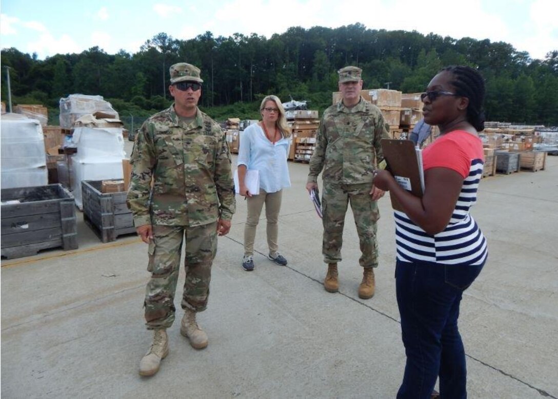 Army Lt. Col. Michael Lindley, DLA Distribution Anniston, Ala., commander, talks with Army Brig. Gen. John Laskodi, DLA Distribution commander, about the incoming volume of material at the distribution center and the organization's support to DLA Disposition Services.  Also pictured are Jennifer Watson, DLA Distribution Anniston operations officer, and Latoya Twymon, DLA Distribution Anniston D2 Demilitarization Disposition supervisor.  