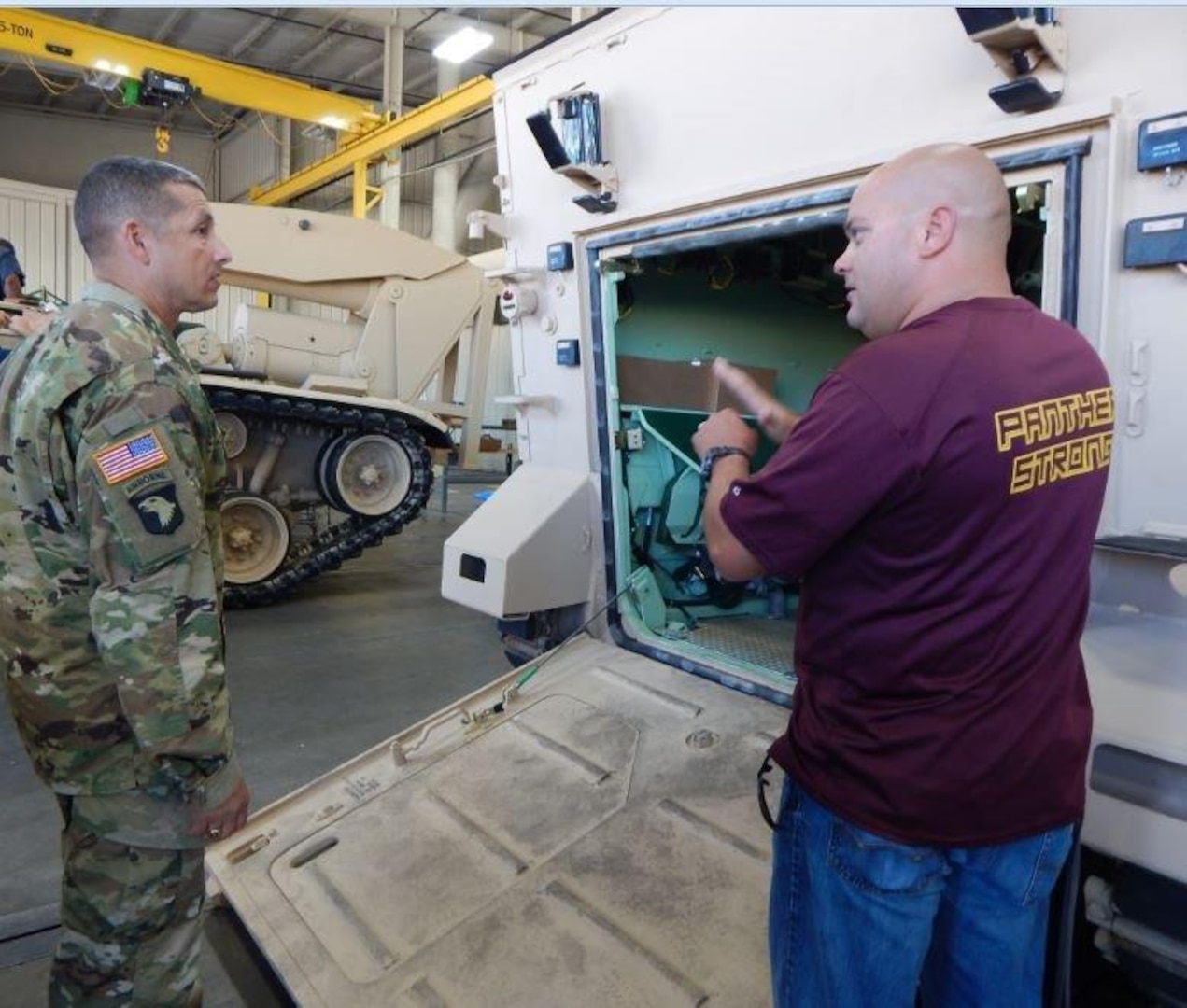 Army Brig. Gen. John Laskodi, DLA Distribution commander, discusses the importance of the preservation process for all incoming and outgoing vehicles and artillery with Marcus Woods, DLA Distribution Anniston, Ala., Vehicles and Artillery Division supervisor.  