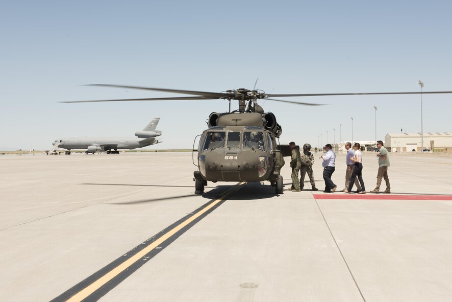 Congressional advisors board a UH-60 Black Hawk at Mountain Home Air Force Base, Idaho, July 19, 2016. They flew to Saylor Creek range where advisors learned about ways the 266th Range Squadron simulates threats to create a more realistic training environment for aircrews. (U.S. Air Force photo by Airman Alaysia Berry/Released)