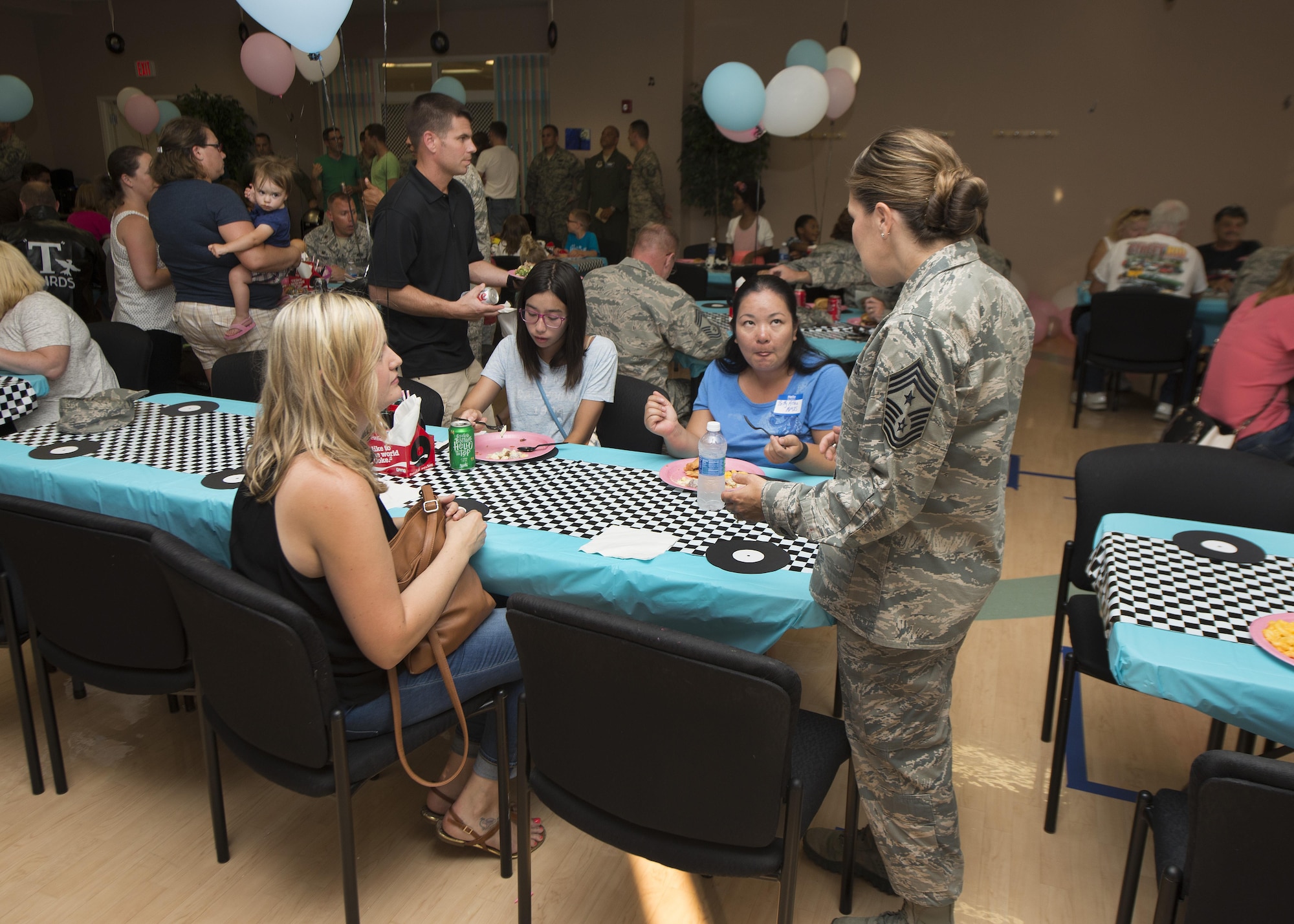 Chief Master Sgt. Sarah Sparks, 436th Airlift Wing command chief, speaks to Team Dover family members during the Summer Deployed Families Dinner July 21, 2016, at the Youth Center on Dover Air Force Base, Del. The dinner is open to all deployed Team Dover Airmen’s family members. (U.S. Air Force photo/Senior Airman Zachary Cacicia)