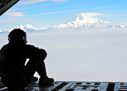 U.S. Air Force Senior Airman Jordon Speedy, 41st Airlift Squadron loadmaster, overlooks the Alaskan landscape July 19, 2016. The 41st AS is conducting training in Alaska to prepare for the terrain present in austere locations. Alaska provides an uncontended airspace which allows aircrews to train more effectively without having to adjust to commercial flight patterns. 