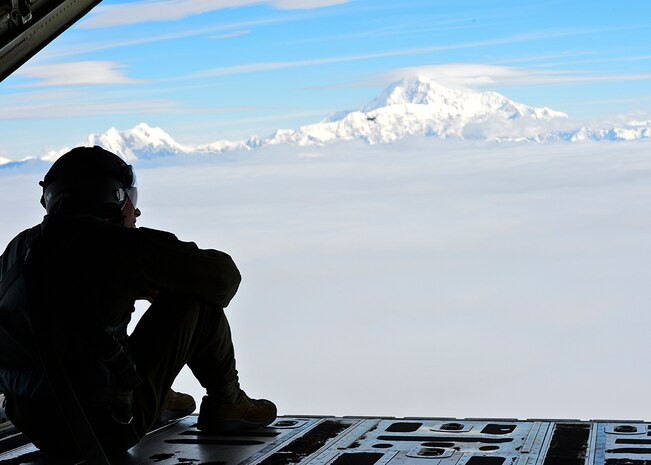 U.S. Air Force Senior Airman Jordon Speedy, 41st Airlift Squadron loadmaster, overlooks the Alaskan landscape July 19, 2016. The 41st AS is conducting training in Alaska to prepare for the terrain present in austere locations. Alaska provides an uncontended airspace which allows aircrews to train more effectively without having to adjust to commercial flight patterns. 