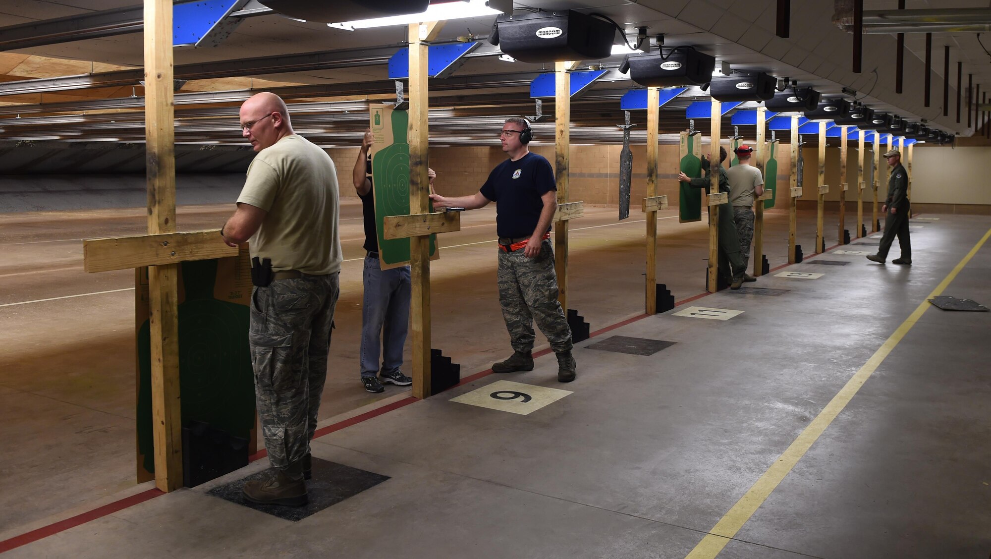 U.S. Air Force Airmen prepare their targets before a firing sequence July 8, 2016, at Dyess Air Force Base, Texas. Six Airmen were selected to fire as part of beta test for the Shooting Proficiency program. If implemented, Dyess Airmen would be allowed to bring privately own firearms to the base combat arms training and maintenance firing range and shoot recreationally while under the supervision of CATM instructors. (U.S. Air Force photo by Senior Airman Alexander Guerrero/Released)