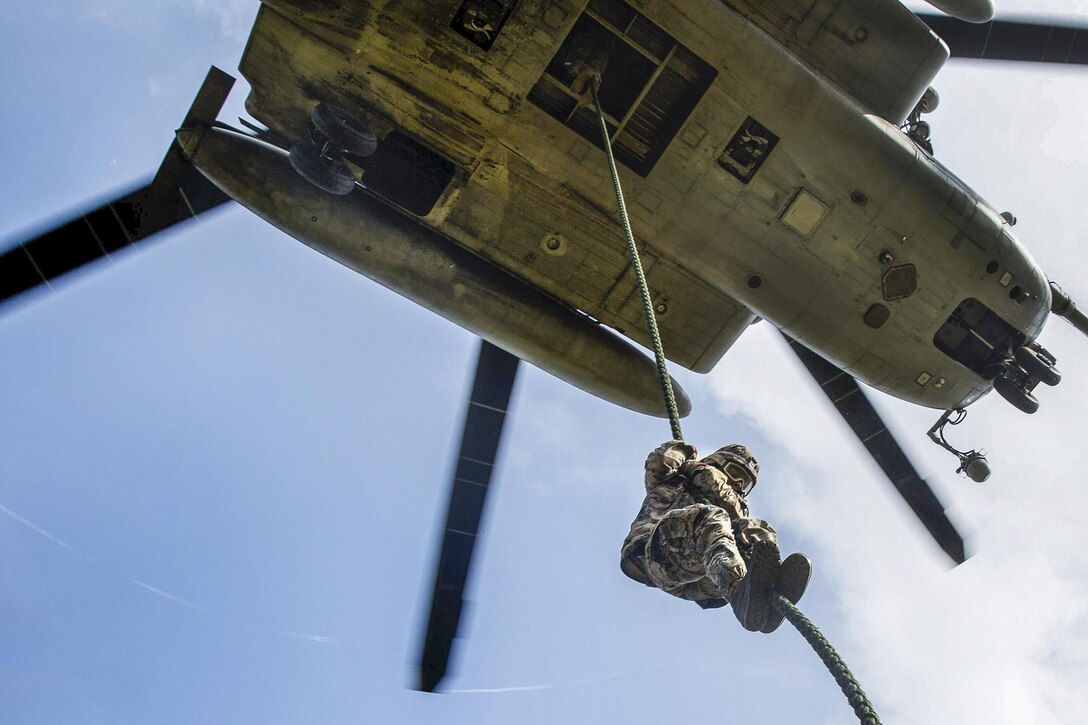 A Marine student fast-ropes out of a CH-53E Super Stallion helicopter during operations at Camp Lejeune, N.C., July 13, 2016. The course is a new, shortened version of the helicopter rope-suspension training course and focuses on qualifying Marines as subject matter experts within their subordinate command. Marine Corps photo by Lance Cpl. Preston McDonald
