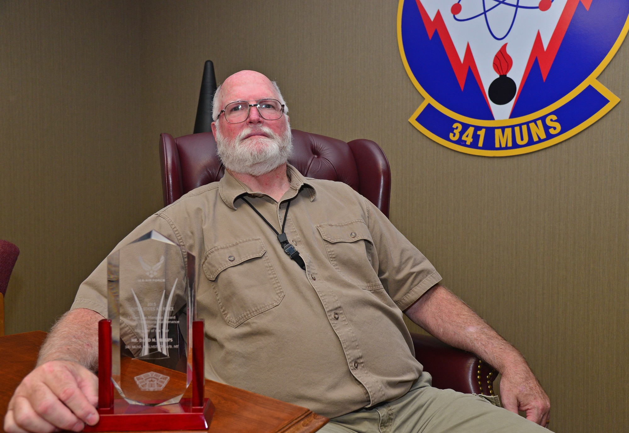 David Phillips, 341st Munitions Squadron technical advisor and equipment specialist, sits with his 2015 Lt. Gen. Leo Marquez Air Force level award July 20, 2016, at Malmstrom Air Force Base, Mont. This award is Phillips’ first Air Force level award in his career. (U.S. Air Force photo/Airman 1st Class Daniel Brosam)