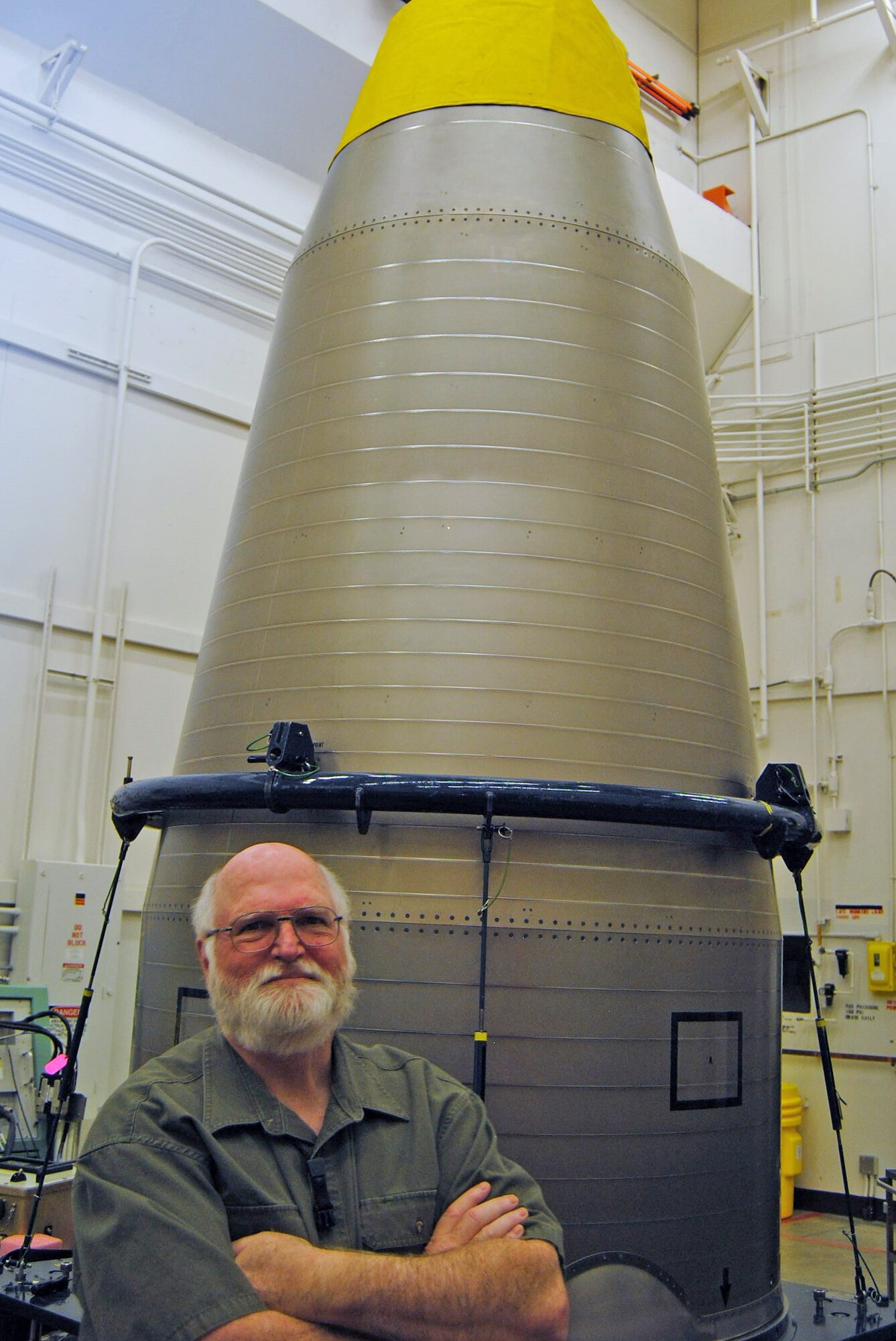 David Phillips, 341st Munitions Squadron technical advisor and equipment specialist, poses with a re-entry aft shroud March 2016, at Malmstrom Air Force Base, Mont. Phillips is a retired Air Force master sergeant who has worked with missiles for more than 30 years and received his first Air Force-level award. (courtesy photo)