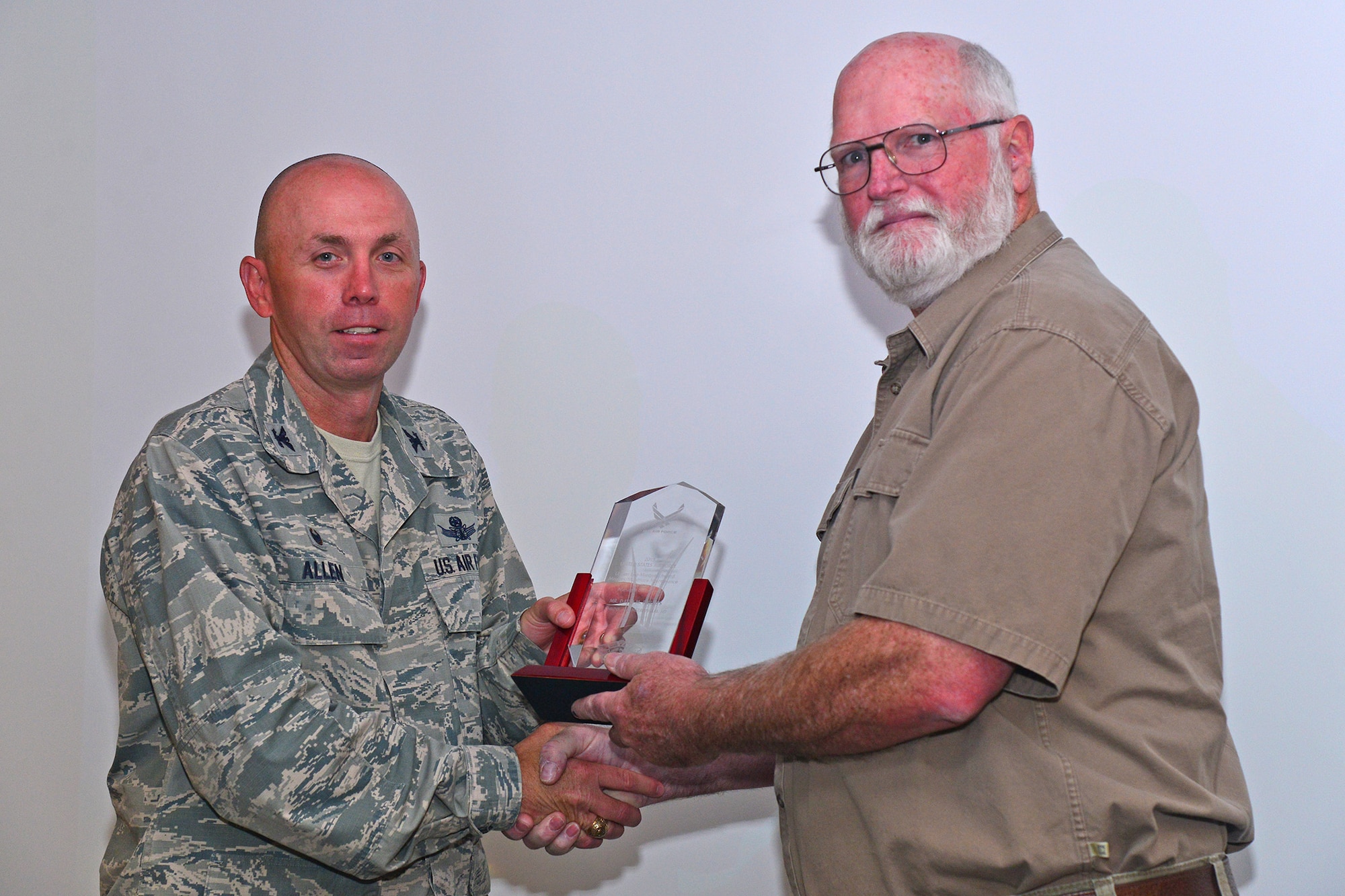 Col. Ron Allen, 341st Missile Wing commander, presents David Phillips, 341st Munitions Squadron technical advisor and equipment specialist, with the 2015 Lt. Gen. Leo Marquez Air Force level award July 20, 2016, at Malmstrom Air Force Base, Mont. The award recognizes maintenance professionals in the aircraft, munitions, missile and communications fields for sustained job performance, knowledge and involvement in their duties. (U.S. Air Force photo/Airman 1st Class Daniel Brosam)