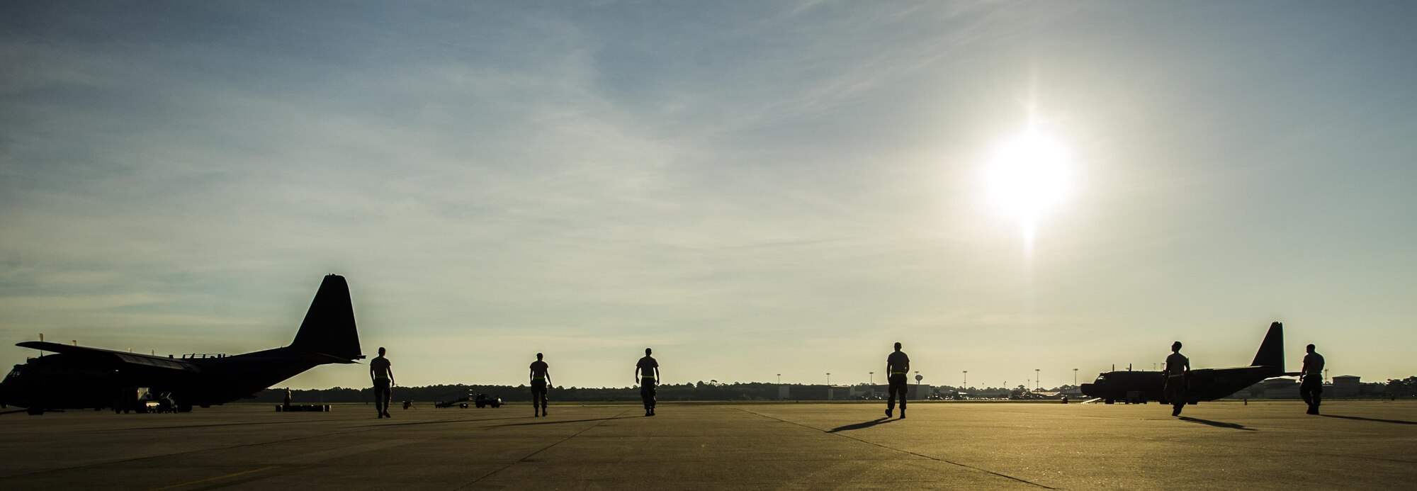 Air Commandos from the 15th Aircraft Maintenance Unit perform a foreign object damage walk at Hurlburt Field, Fla., July 20, 2016. During a F.O.D. walk, Airmen spread out and pick up any loose objects they see that could damage the aircraft. (U.S. Air Force photo by Airman 1st Class Isaac O. Guest)
