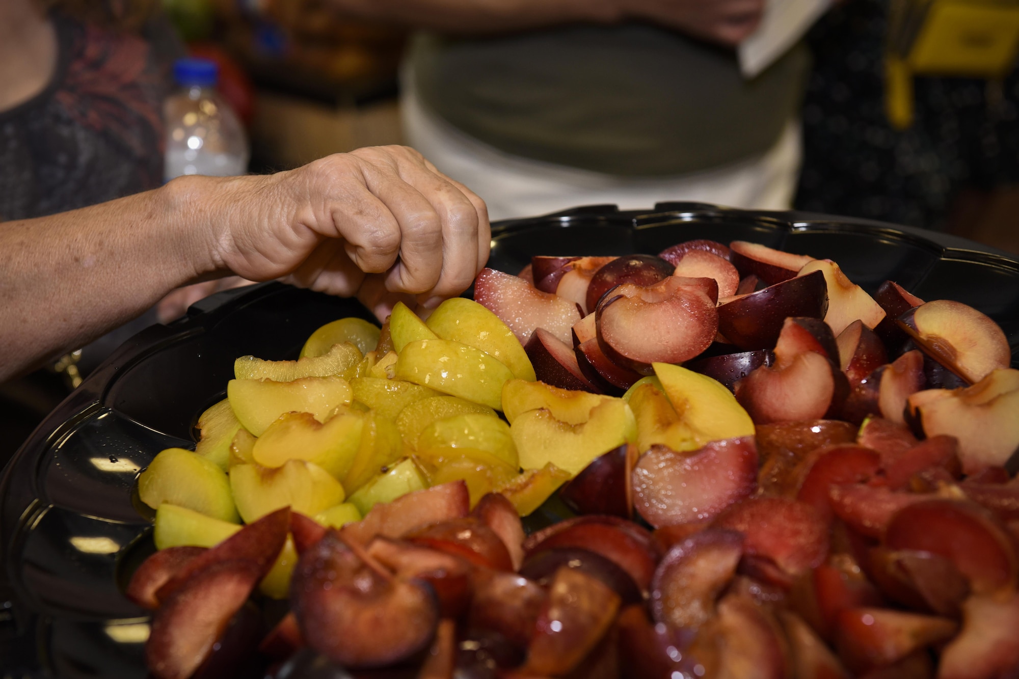 PETERSON AIR FORCE BASE, Colo. – A participant in the Fruit and Veggies – Eat More Tour tries different pluot, a hybrid between a plum and an apricot, varieties at the commissary on Peterson Air Force Base, Colo., July 21, 2016. The Health and Wellness Center at Peterson teamed up with the commissary to provide a new educational source for Team Pete to learn more about local healthier options available. (U.S. Air Force photo by Senior Airman Rose Gudex)  
