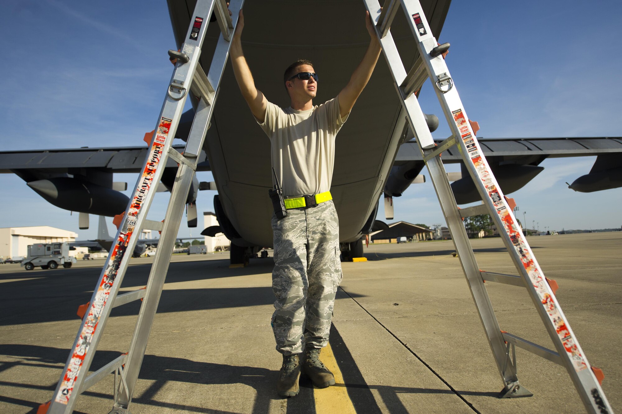 Staff Sgt. Nick Kimmel, a crew chief assigned to the 901st Special Operations Aircraft Maintenance Squadron, holds a ladder steady while working on a MC-130H Combat Talon II aircraft before pre-flight inspection at Hurlburt Field, Fla., July 20, 2016. Crew chief’s take care of day-to-day maintenance, including end-of-runway, post-flight, preflight, thru-flight, special inspections and phase inspections. (U.S. Air Force photo by Airman 1st Class Isaac O. Guest)