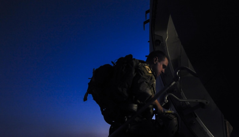 A Survival Evasion Resistance Escape Specialist, assigned to the 414th Combat Training Squadron, enters a C-17 before a training mission during Red Flag 16-3 at Nellis Air Force Base, Nev., July 20, 2016. Red Flag involves a variety of attack, fighter, bomber, reconnaissance, electronic warfare, airlift support, and search and rescue aircraft. (U.S. Air Force photo by Airman 1st Class Kevin Tanenbaum/Released)