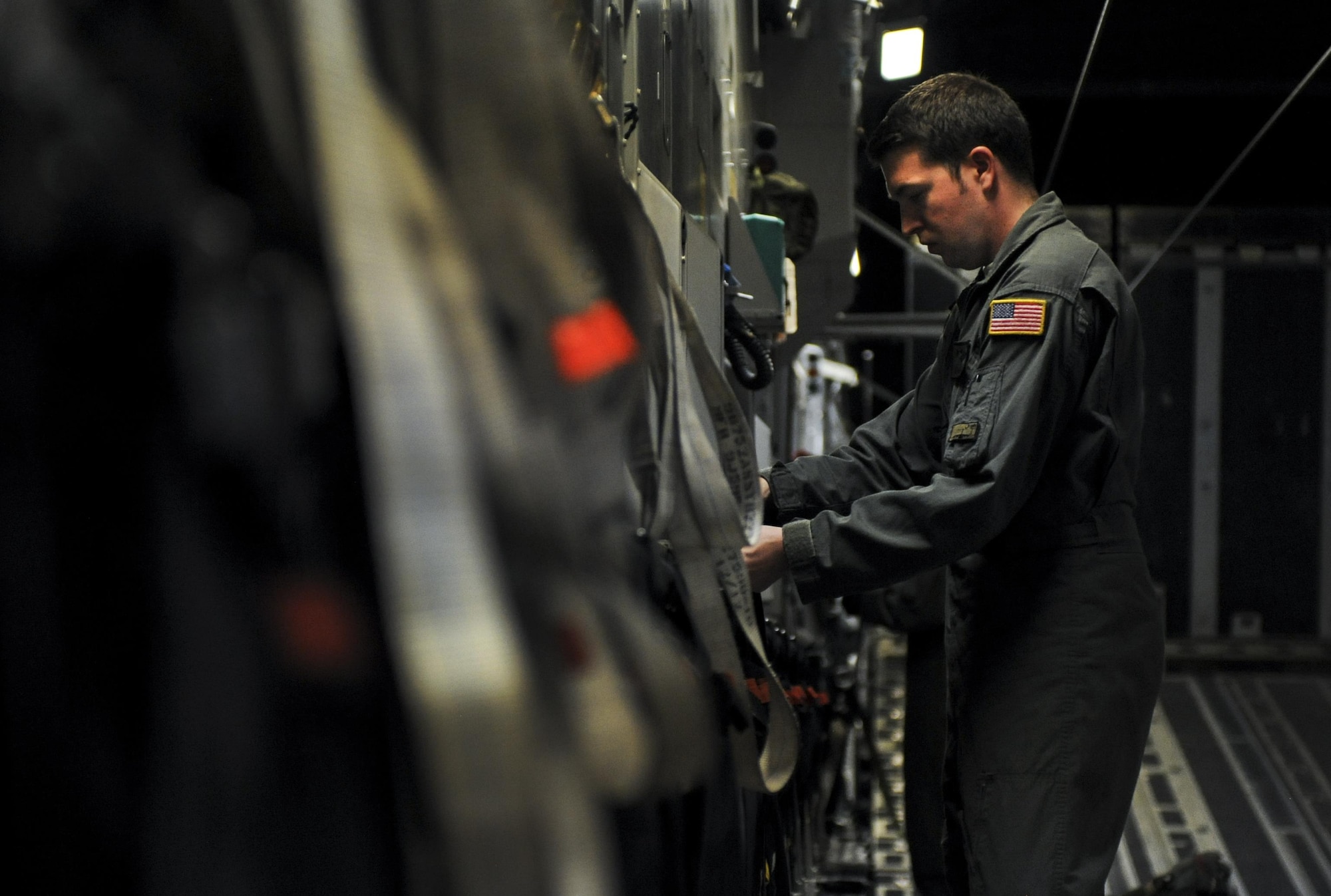 Senior Airman Nick Church, 437th Airlift Wing, Joint Base Charleston, S.C., loadmaster, places seats upright before take-off inside a C-17 during Red Flag 16-3 at Nellis Air Force Base, Nev., July 20, 2016. Red Flag is a realistic combat training exercise involving the air, space and cyber forces of the U.S. and its allies. (U.S. Air Force photo by Airman 1st Class Kevin Tanenbaum/Released)