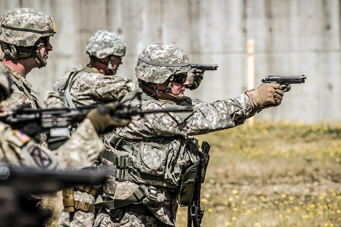 Soldiers conduct a reflexive-fire exercise at Joint Base Lewis-McChord, Wash., July 15, 2016. The soldiers trained with both the M4 carbine and M9 pistol to enhance tactical proficiency. U.S. Army photo by Capt. Brian Harris