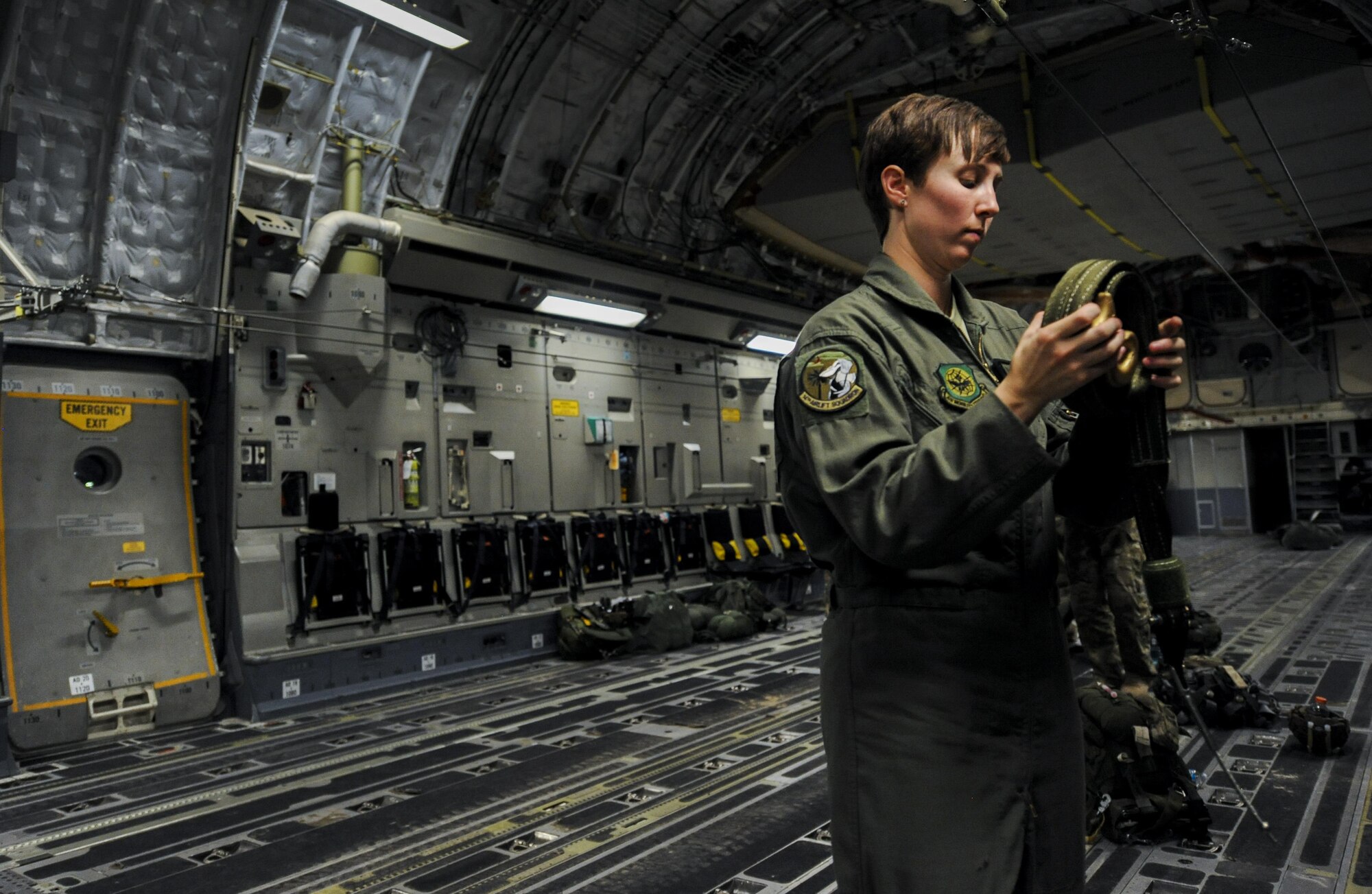 Senior Airman Ashley Igalo, 437th Airlift Wing, Joint Base Charleston, S.C., loadmaster, prepares the interior of a C-17 for Survival Evasion Resistance Escape specialist’s static line jumps during Red Flag 16-3 at Nellis Air Force Base, Nev., July 20, 2016. All four branches of the U.S. Military participate in the Red Flag training conducted on the vast bombing and gunnery ranges of the Nevada Test and Training Range. (U.S. Air Force photo by Airman 1st Class Kevin Tanenbaum/Released)