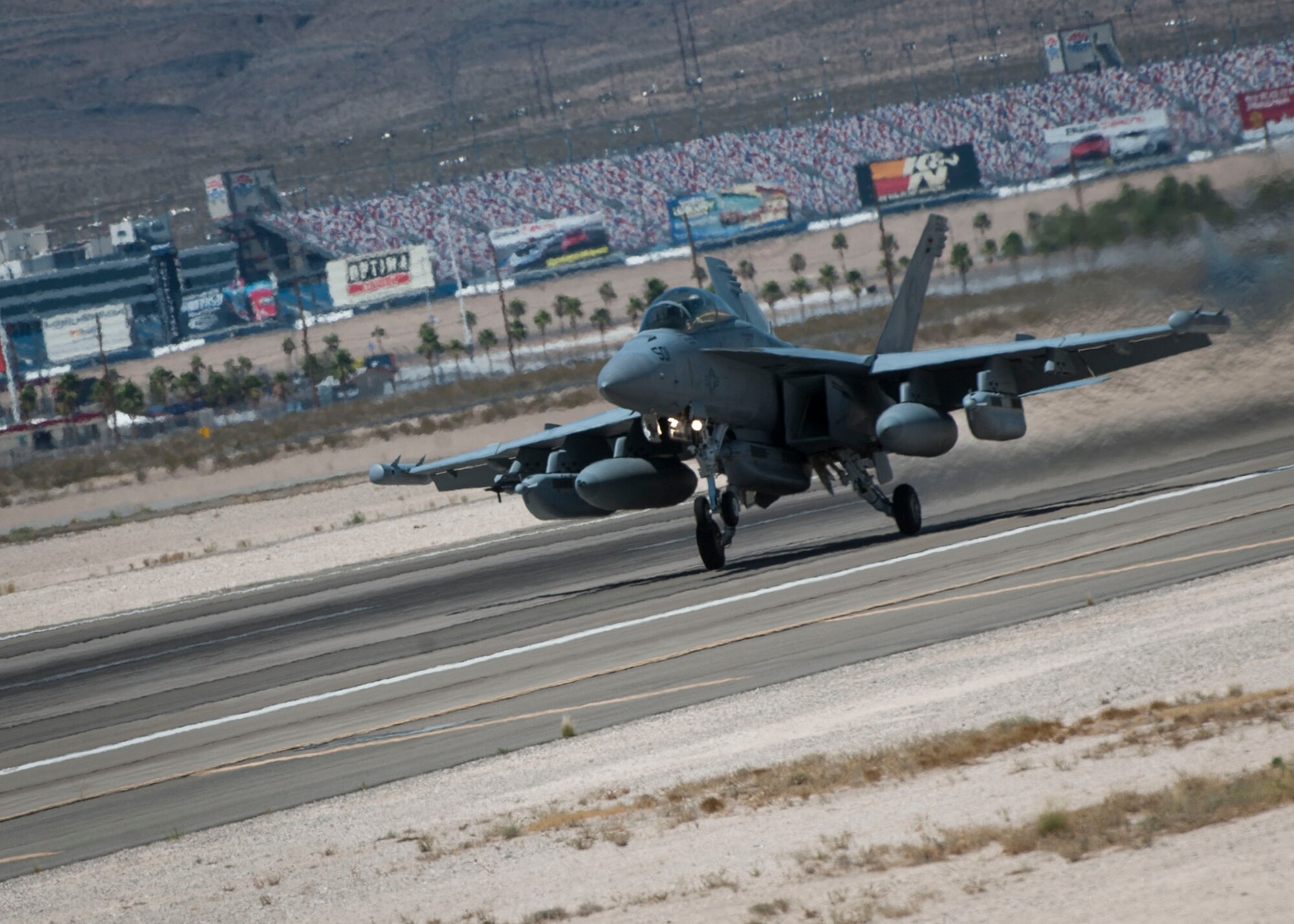 An Navy EA-18G from Naval Air Station Whidbey Island, Washington, speeds down the Nellis flightline for takeoff during Red Flag 16-3 July 19, 2016. During the exercise, the EA-18G is able to perform electronic warfare in support of air and ground forces. (U.S. Air Force photo by Senior Airman Jake Carter)