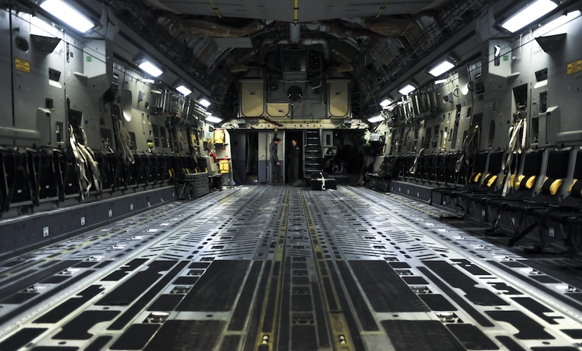 Senior Airmen Nick Church and Ashley Igalo, 437th Airlift Wing, Joint Base Charleston, S.C., loadmasters, prepare the interior of a C-17 before take-off during Red Flag 16-3 at Nellis Air Force Base, Nev., July 20, 2016. Red Flag provides a series of intense air-to-air scenarios for aircrew and ground personnel which will increase their combat readiness and effectiveness for future real world missions. (U.S. Air Force photo by Airman 1st Class Kevin Tanenbaum/Released)