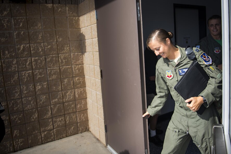 U.S. Air Force Capt. Christy Wise, 71st Rescue Squadron pilot, steps through the rear door of the 71st RQS building to begin her walk to the flightline for her first flight since becoming an above-the-knee amputee, July 22, 2016, at Moody Air Force Base, Ga. Wise became an amputee after a boating accident in April of 2015. (U.S. Air Force Photo by Senior Airman Ryan Callaghan)
