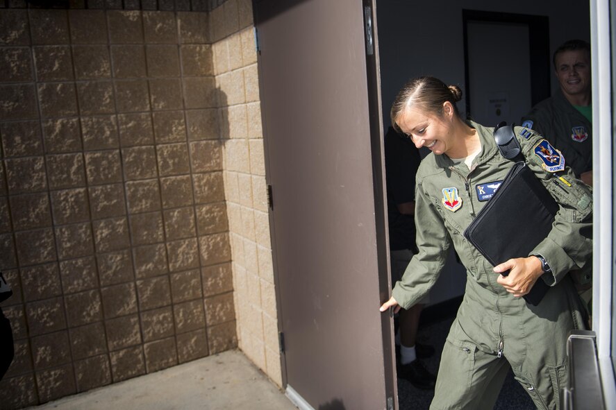U.S. Air Force Capt. Christy Wise, 71st Rescue Squadron pilot, steps through the rear door of the 71st RQS building to begin her walk to the flightline for her first flight since becoming an above-the-knee amputee, July 22, 2016, at Moody Air Force Base, Ga. Wise became an amputee after a boating accident in April of 2015. (U.S. Air Force Photo by Senior Airman Ryan Callaghan)
