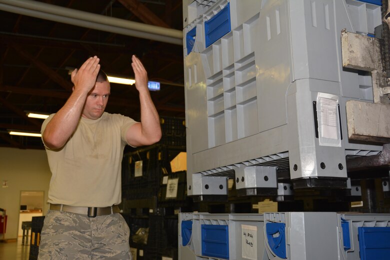 Staff Sgt. Cody Fry, a supply technician at the 507th Logistics Readiness Squadron, monitors placement of pallets in Spangdahlem Air Base, Germany, July 11, 2016. Fry with the rest of the squadron completing annual tour requirements (U.S. Air Force photo/Tech. Sgt. Charles Taylor).