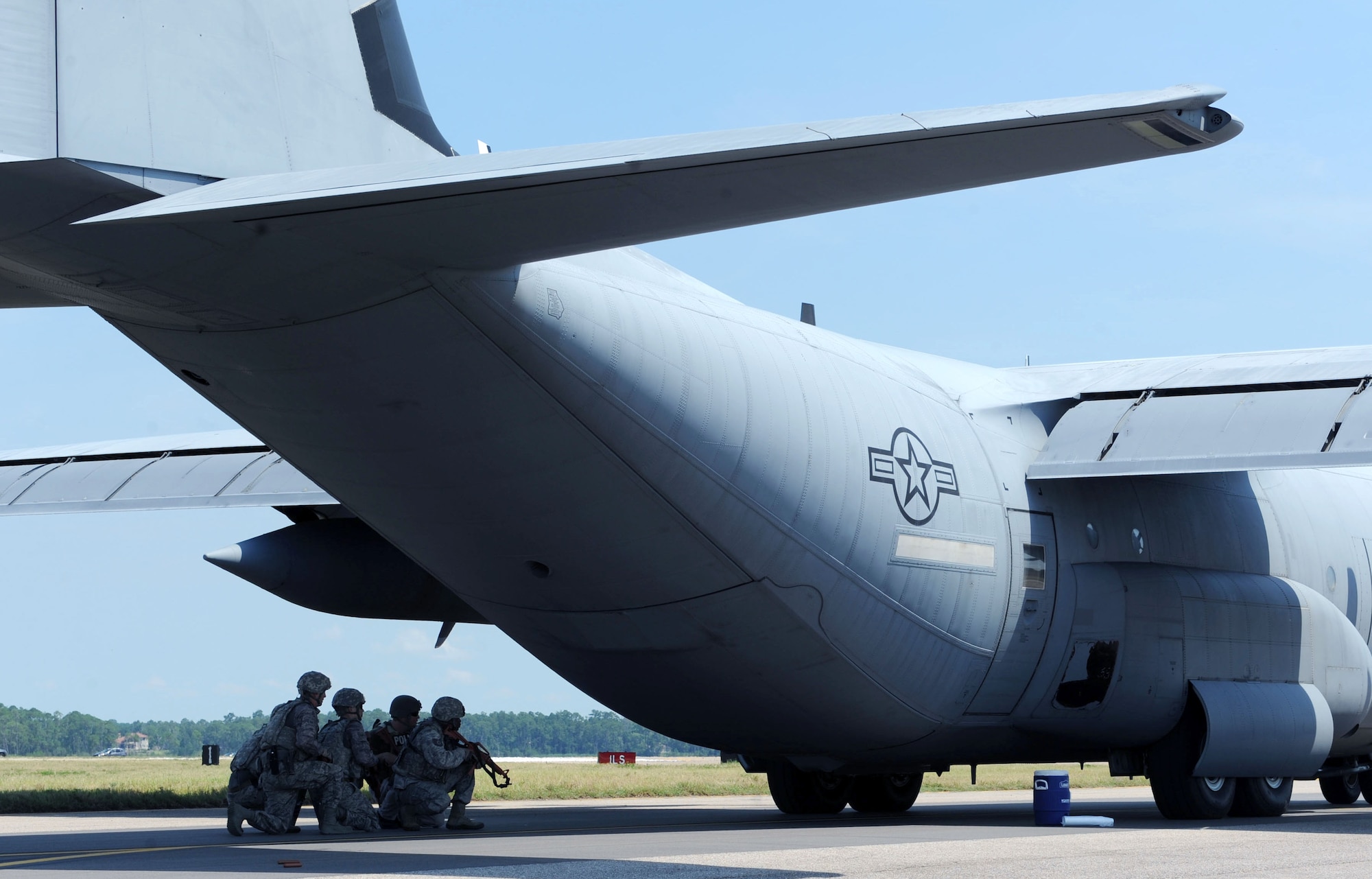Members of the 81st Security Forces Squadron approach a WC-130J Super Hercules in attempt to secure the plane after being “hijacked” during an anti-hijacking exercise on the flightline July 21, 2016, on Keesler Air Force Base, Miss. The exercise was used to test and maintain the ability of Keesler units to react and respond to developing situations. (U.S. Air Force photo by Kemberly Groue/Released)