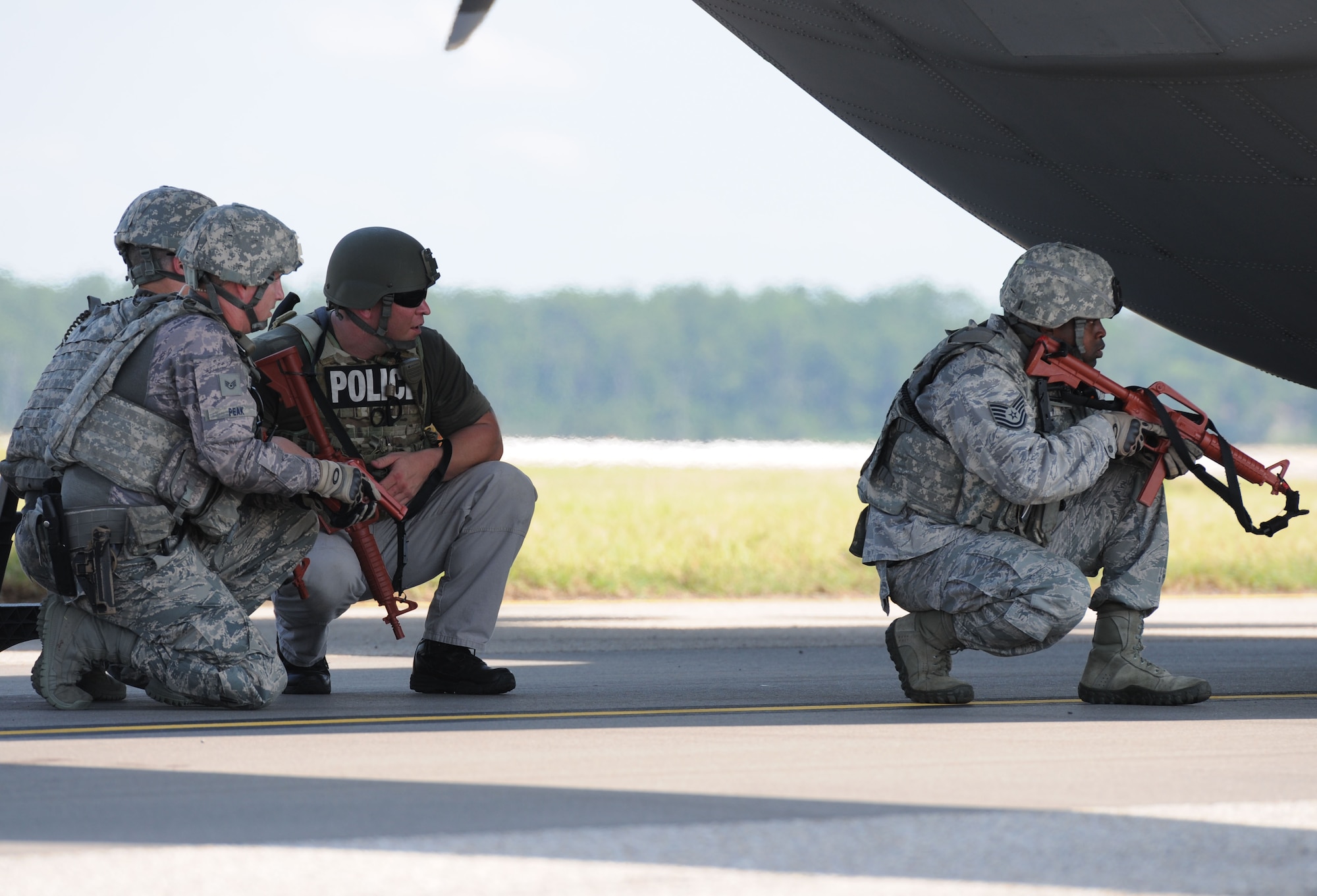 Members of the 81st Security Forces Squadron approach a WC-130J Super Hercules in attempt to secure the plane after being “hijacked” during an anti-hijacking exercise on the flightline July 21, 2016, on Keesler Air Force Base, Miss. The exercise was used to test and maintain the ability of Keesler units to react and respond to developing situations. (U.S. Air Force photo by Kemberly Groue/Released)