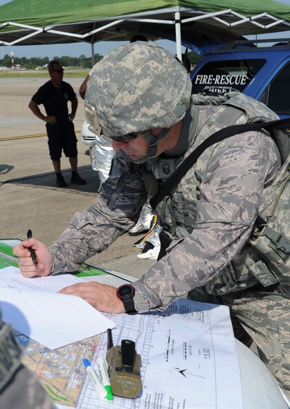 Master Sgt. Joseph Freiesleben, 81st Security Forces Squadron logistics and resources superintendent, coordinates patrol responses and tactical forces positioning in order to secure the incident scene during an anti-hijacking exercise on the flightline July 21, 2016, on Keesler Air Force Base, Miss. The exercise was used to test and maintain the ability of Keesler units to react and respond to developing situations. (U.S. Air Force photo by Kemberly Groue/Released)